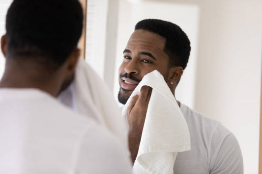 Man touching his beard with towel